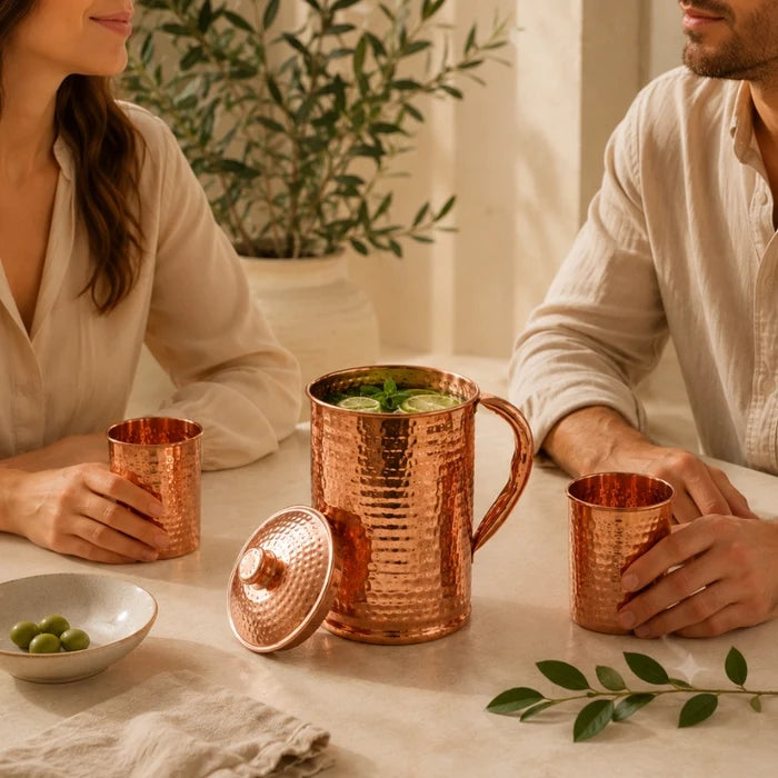 Side view of the hammered copper water carafe showing the curved handle