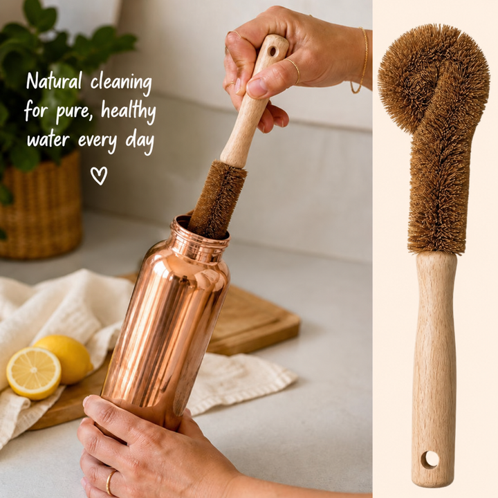 Hands cleaning the inside of a copper water bottle with the natural coconut-fibre brush
