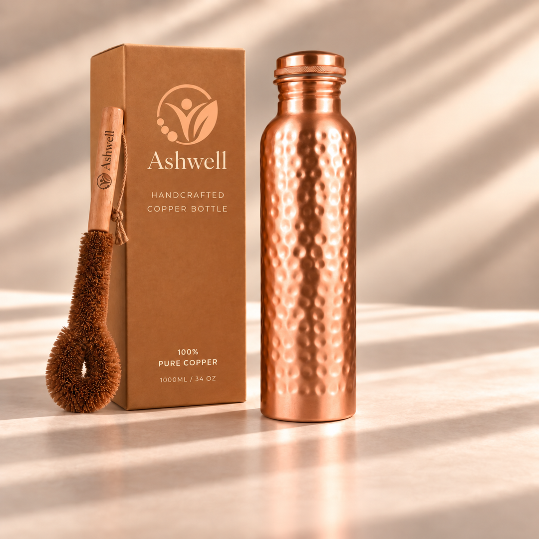 Ashwell copper water bottle displayed with its matching copper cleaning brush