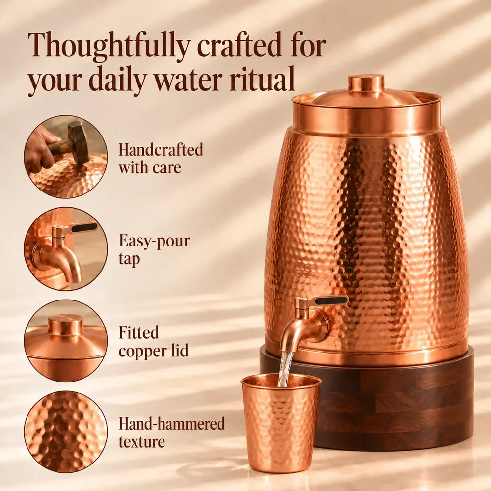 Hammered copper water dispenser displayed on a walnut stand