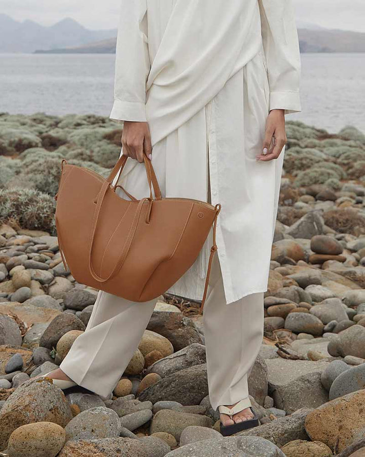 Cyme textured leather tote camel side profile luxury handbag