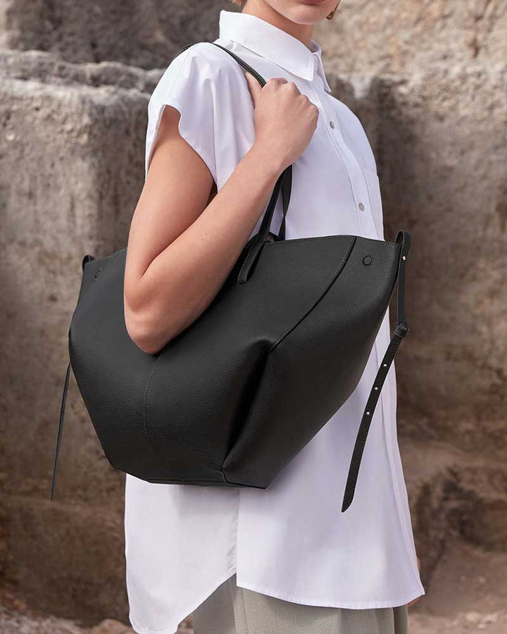 Cyme luxury leather tote bag black side profile designer handbag
